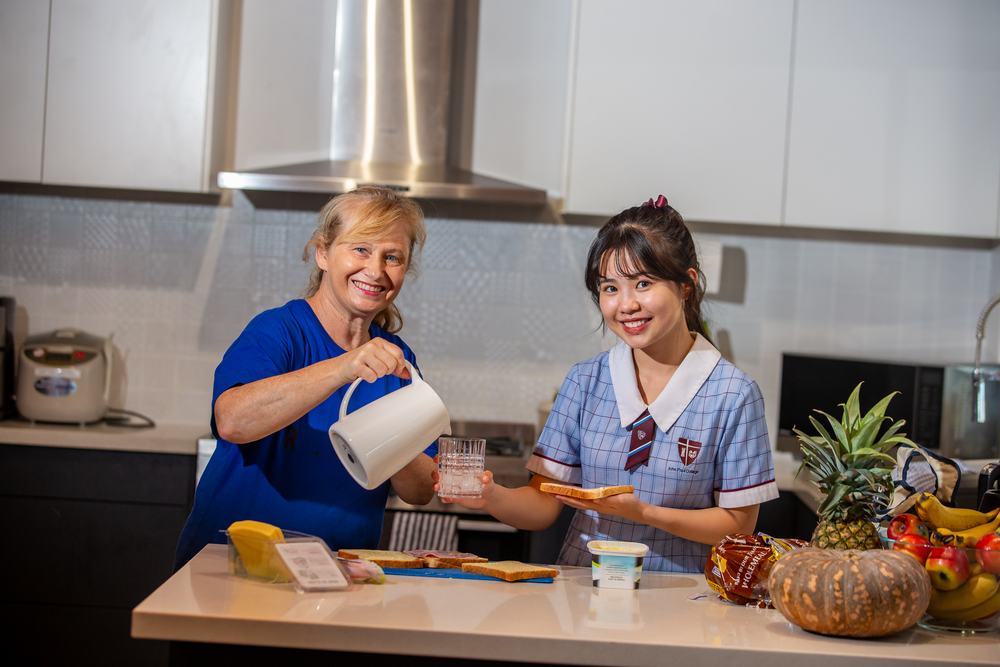 A homestay student having breakfast with their host mother